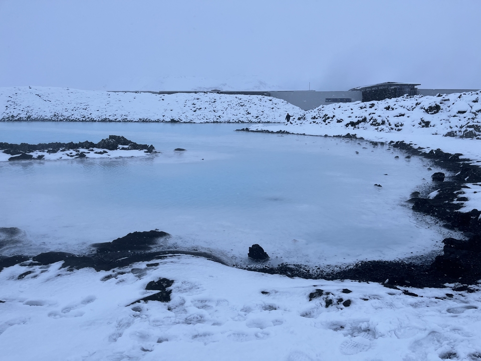 A frozen body of water with snow-covered banks.