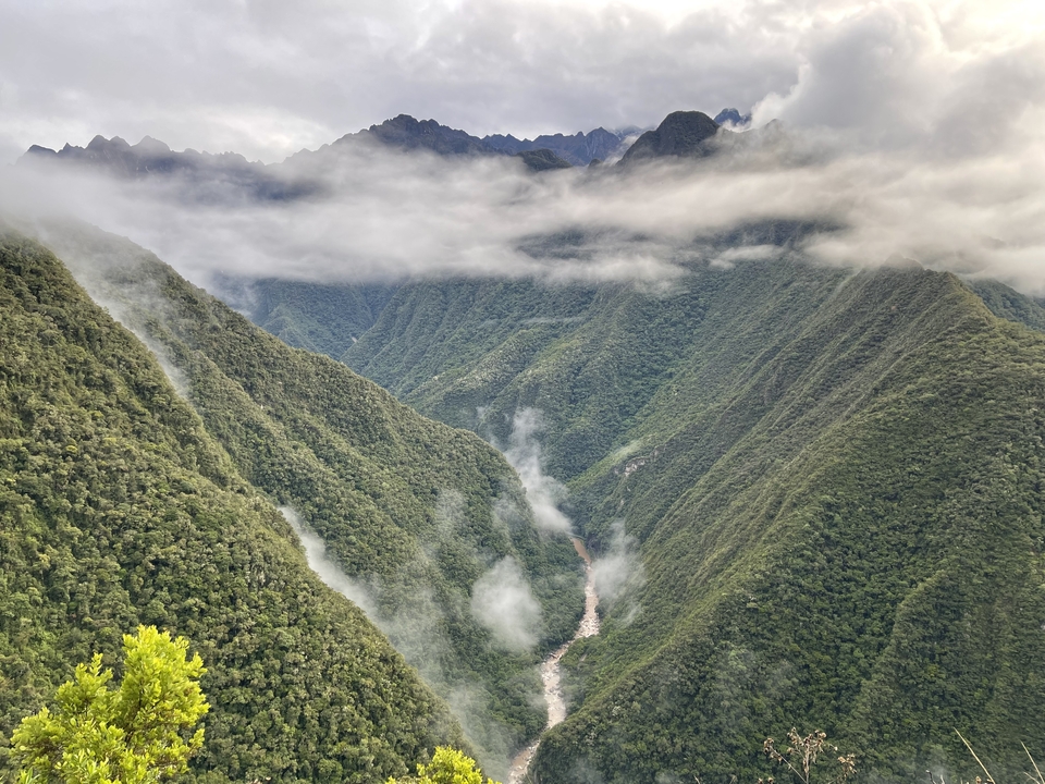A scenic view of a foggy valley with mountains.