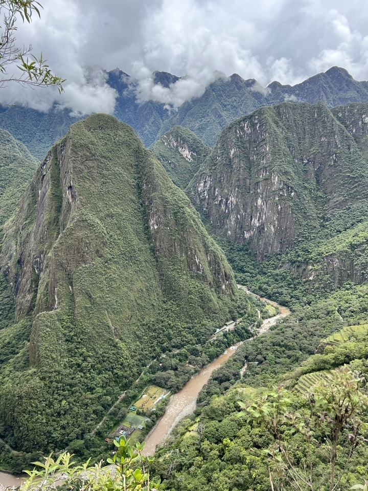 A mountain range with a river flowing through the valley.