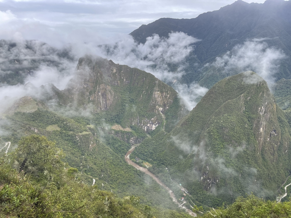 Foggy mountain landscape with a river running through.
