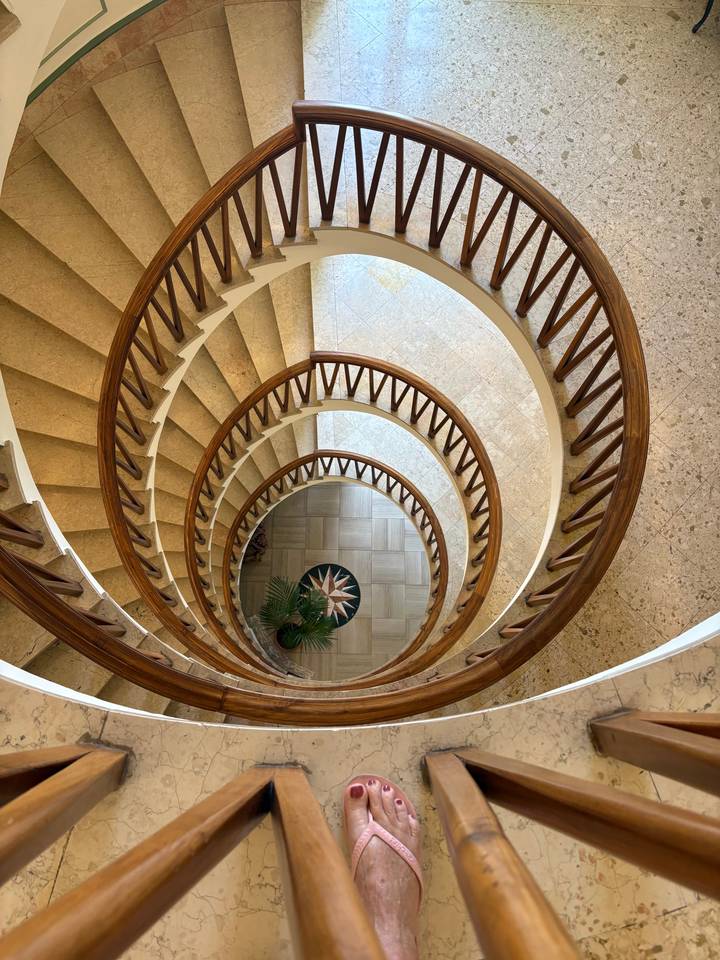 Spiral staircase with a foot visible.