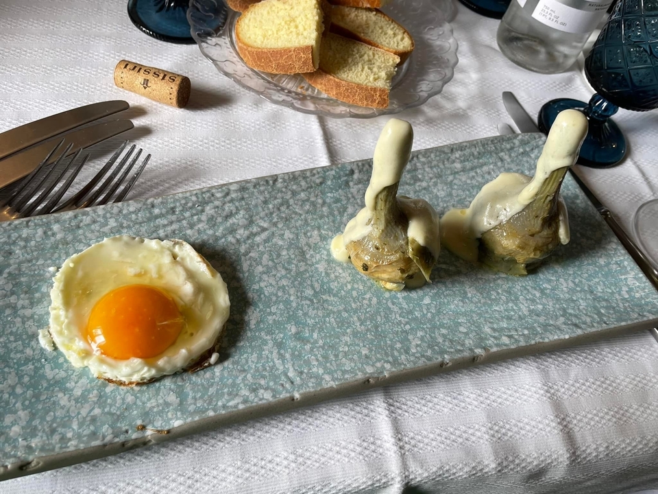 Plate with artichokes, cheese, and egg.