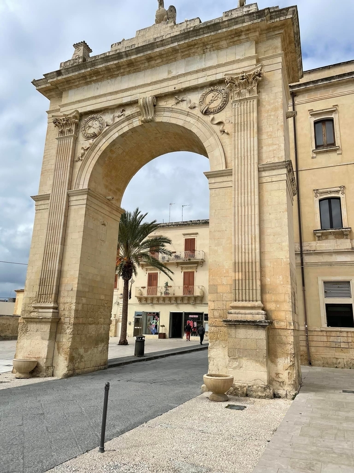 Large stone archway with classical architecture.