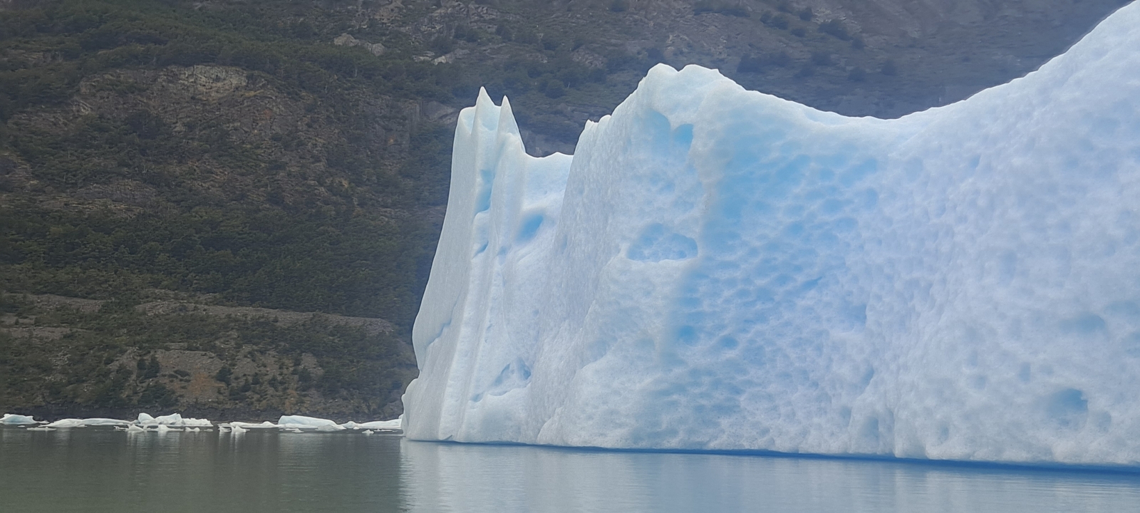 A large iceberg floating in the water.