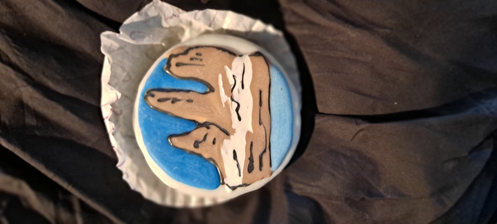 Decorative cookie with a hand-painted mountain and blue sky design.