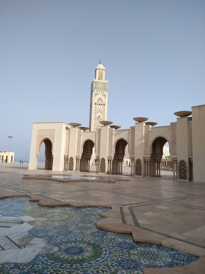 A mosque with intricate architecture and a tall minaret.