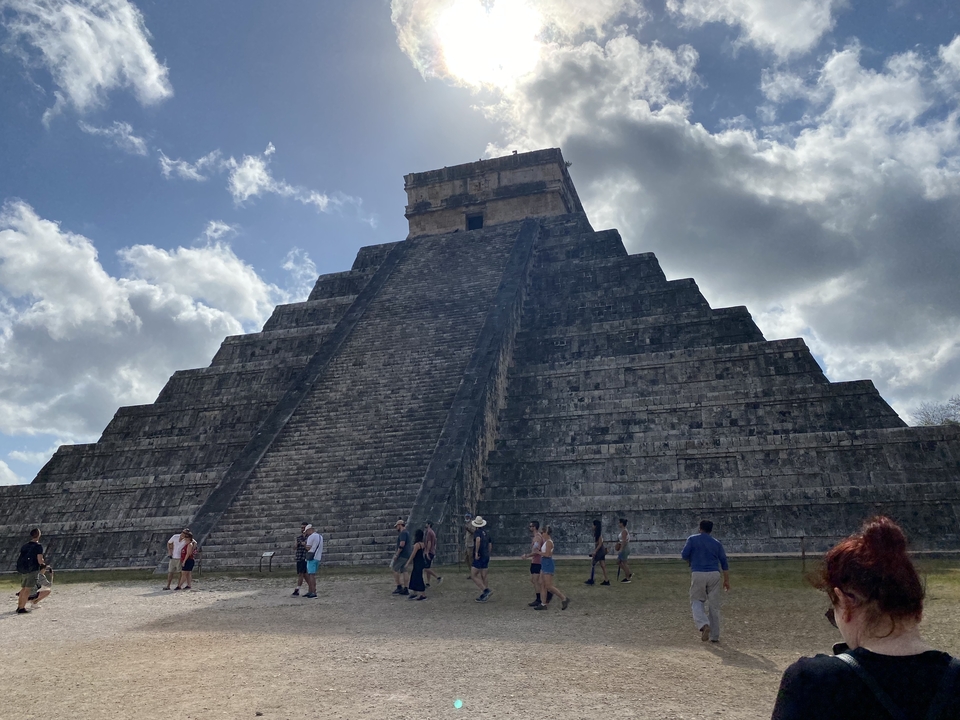 Tourists exploring the iconic pyramid at Chichen Itza.