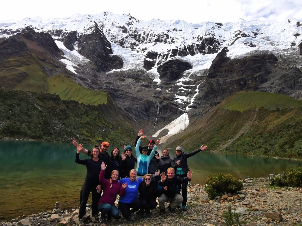 Group in front of a snowy mountain and lake.