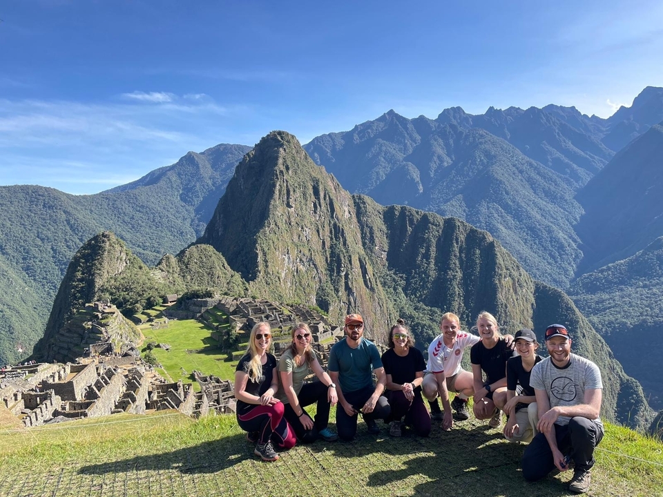 Group posing in front of the Machu Picchu ruins.