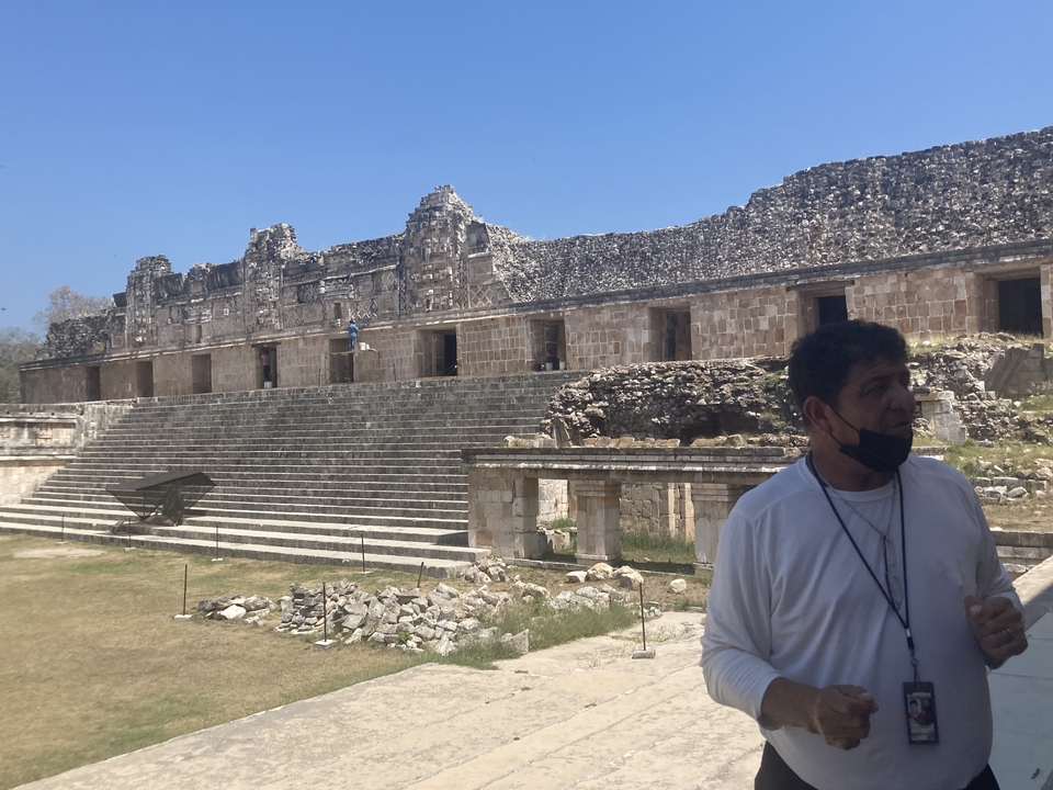 Archaeological ruins with a guide explaining to visitors.