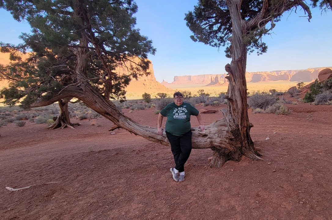 Man posing with a scenic backdrop of Monument Valley.