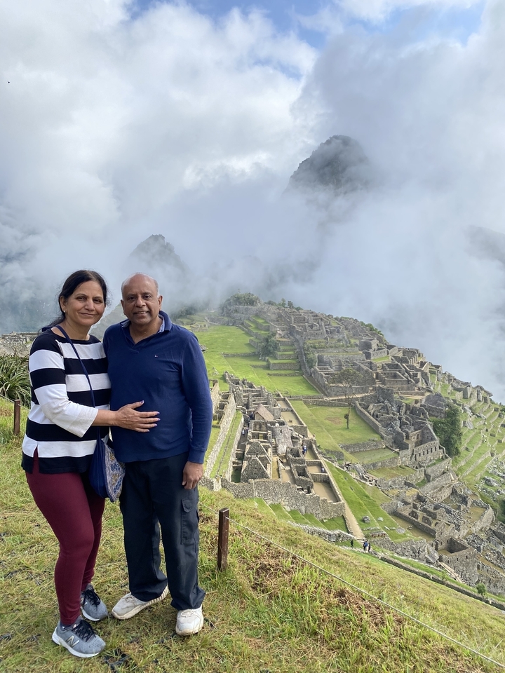 Couple posing with Machu Picchu in the background.
