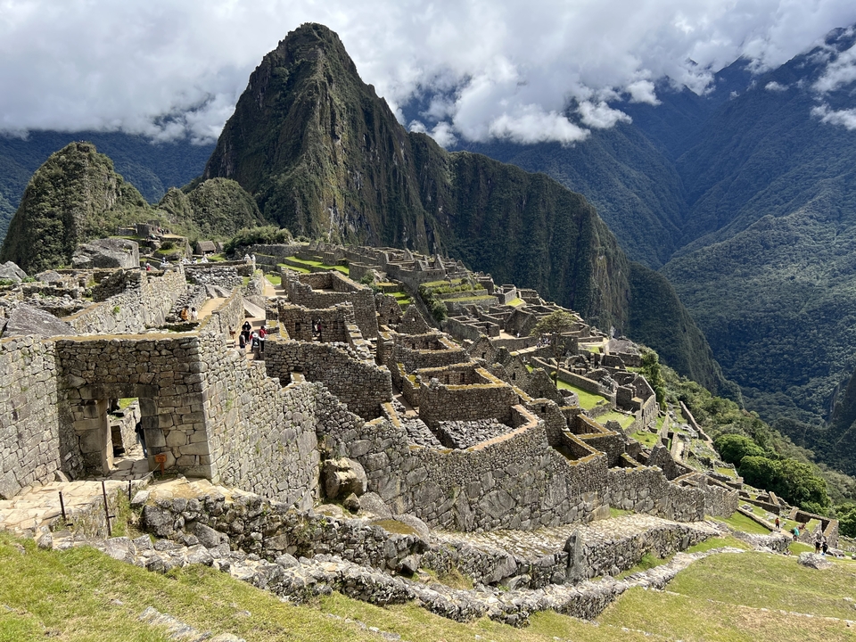 Machu Picchu terraces with scenic mountain backdrop.