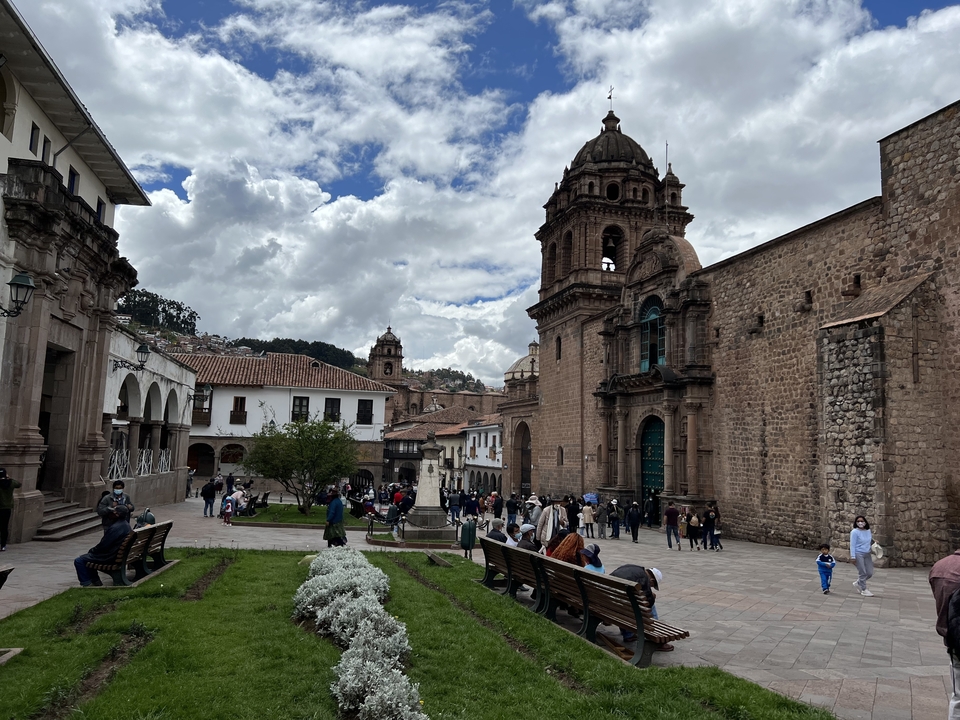 Central Plaza with people gathered in front of historic buildings.