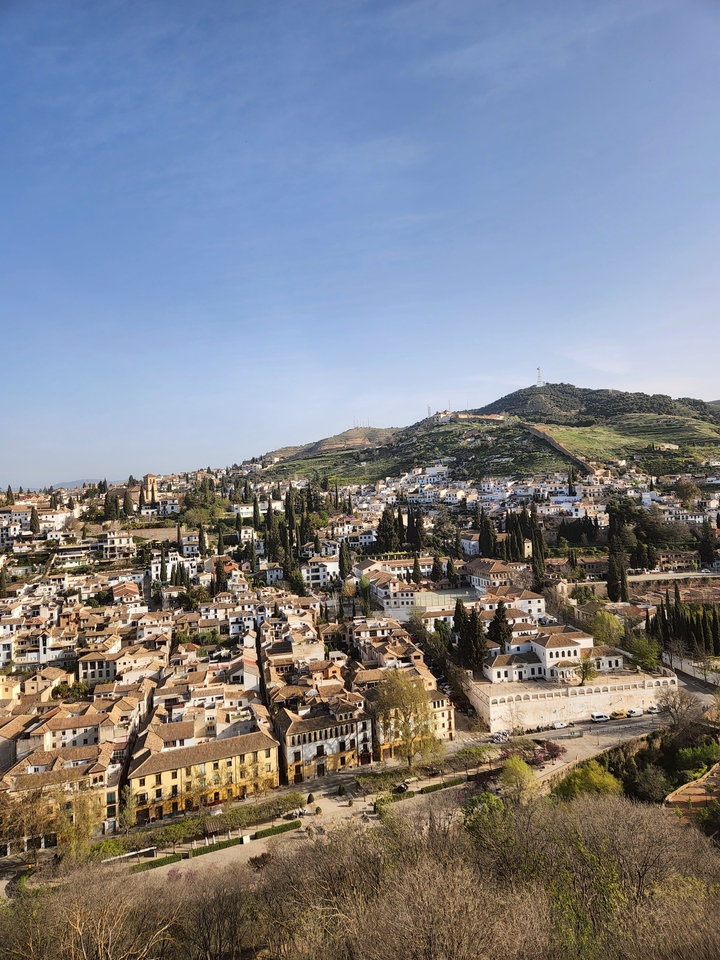 Hillside city under a clear sky.