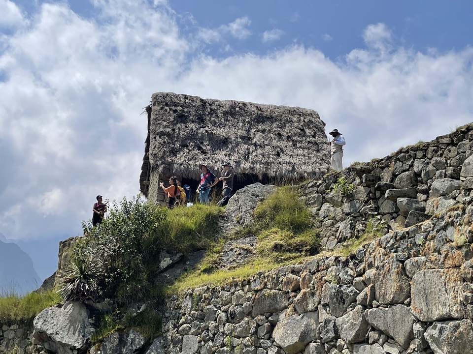 Group of tourists on a hill at an archaeological site.
