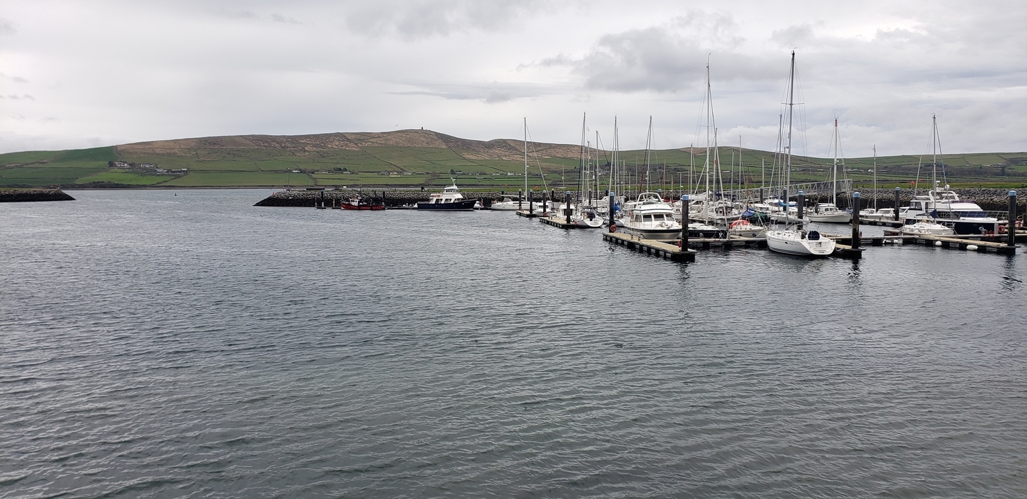 Harbor with boats docked in calm water.