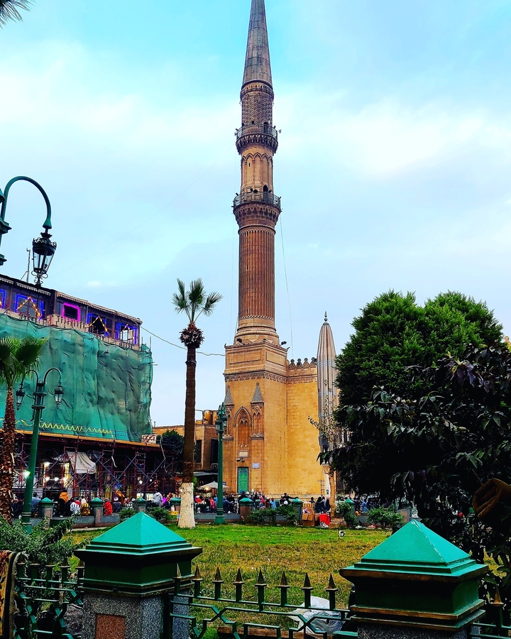 A minaret with surrounding buildings.