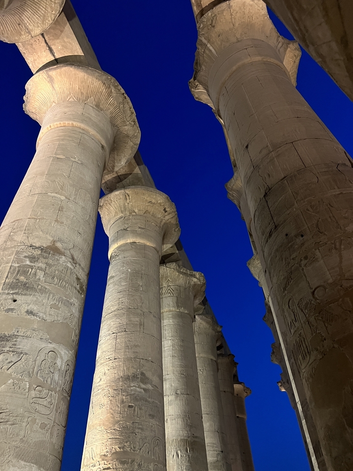 Close-up of illuminated ancient columns at night.