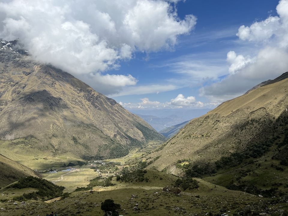 Panoramic view of a valley surrounded by mountains.