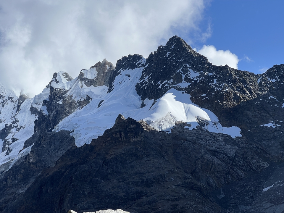 Snow-capped peaks of a mountain range against a clear sky.