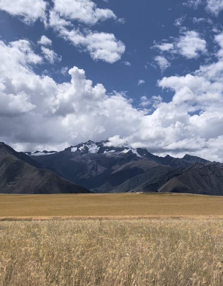 Snow-capped mountains under a partly cloudy sky.