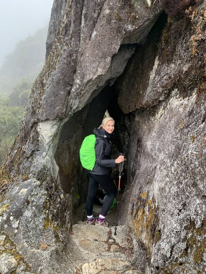 Person resting in a rocky crevice.