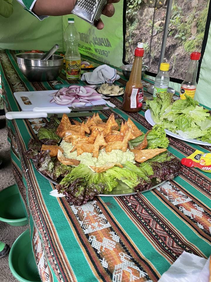 Plate of food featuring lettuce and fried items on a colorful tablecloth.