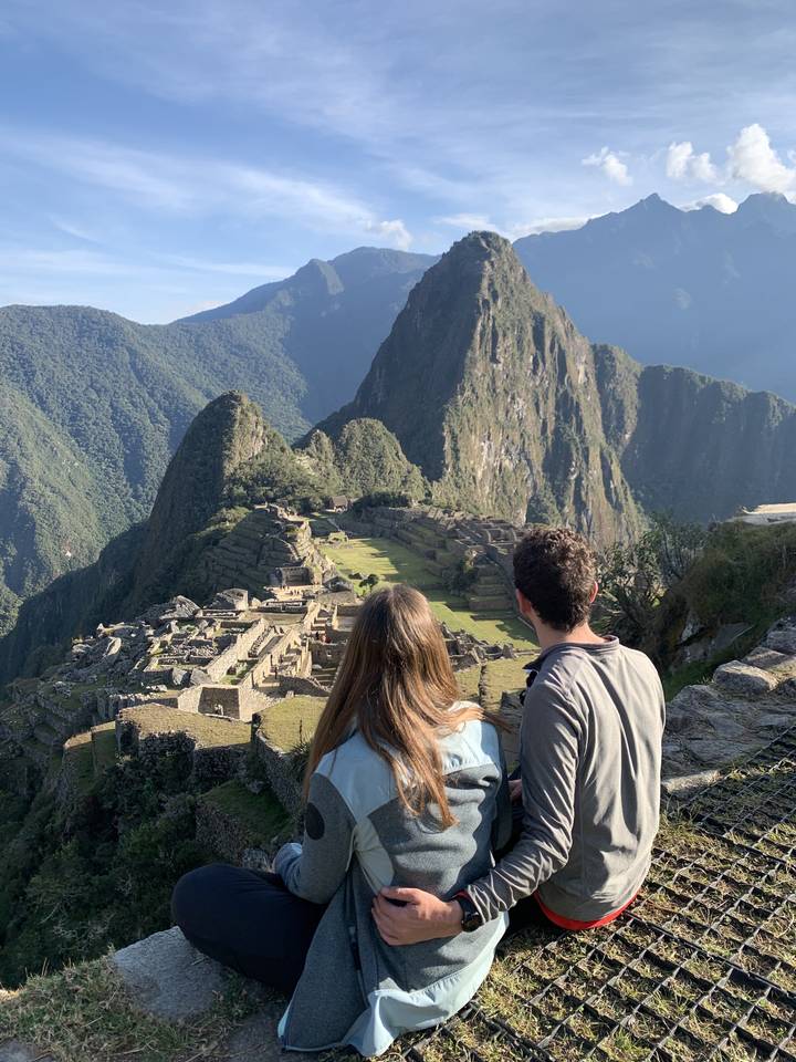 Two people enjoying the view of Machu Picchu.