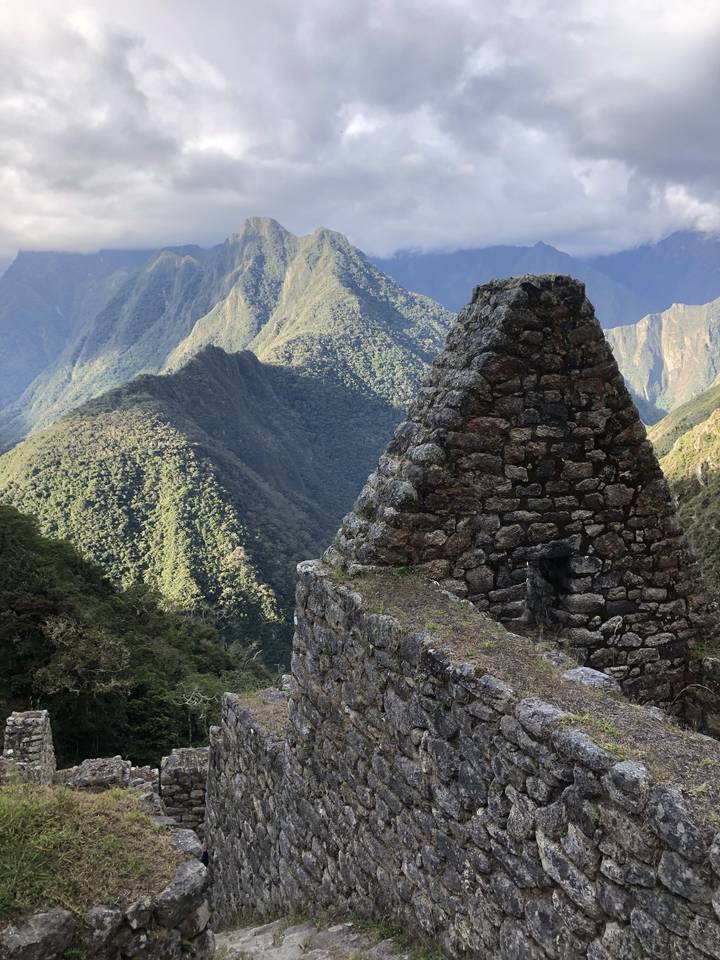 Ancient stone structure with mountain landscape.