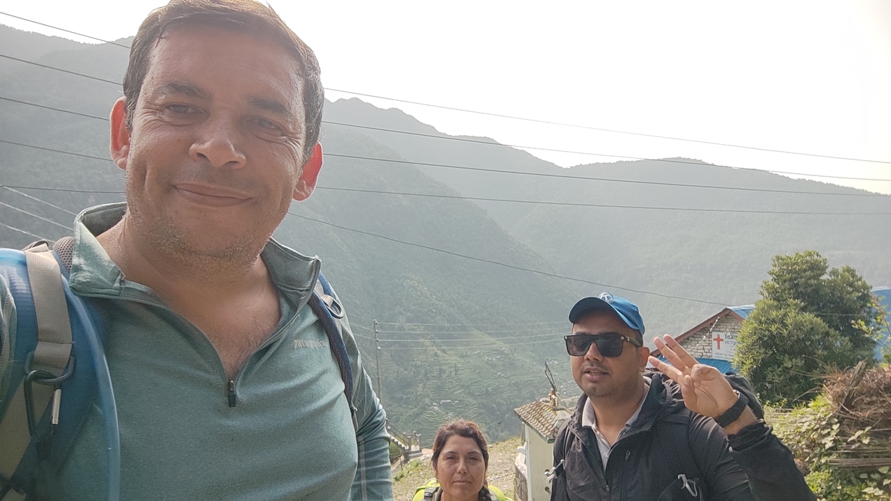 Three people in the mountains.