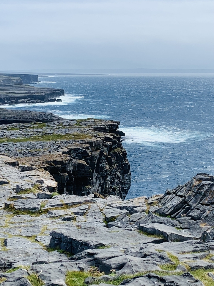 Rocky cliffs against a turbulent sea.