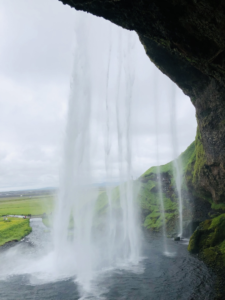 View of a waterfall with lush greenery.