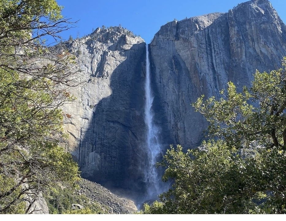 Tall waterfall cascading down a rocky cliff.