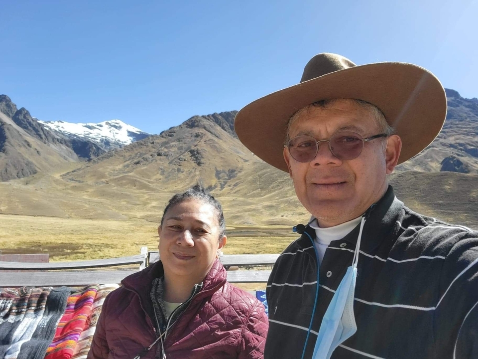 Couple posing with a mountainous landscape.