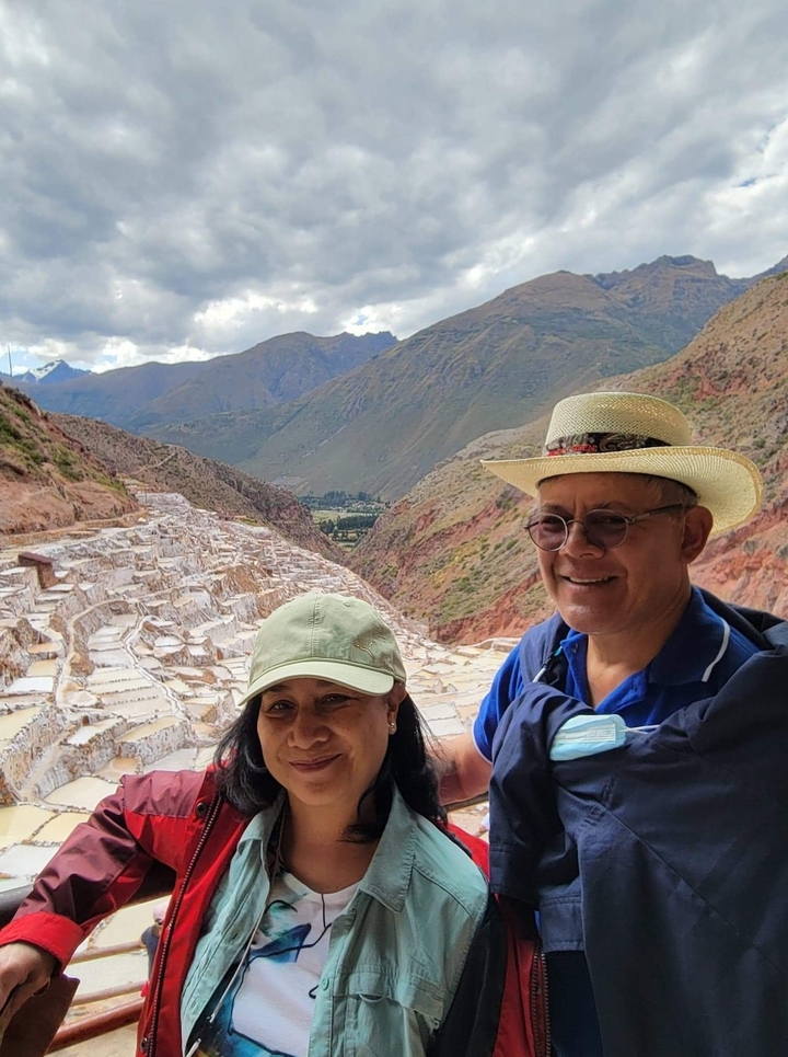 Couple with salt terraces in the background.