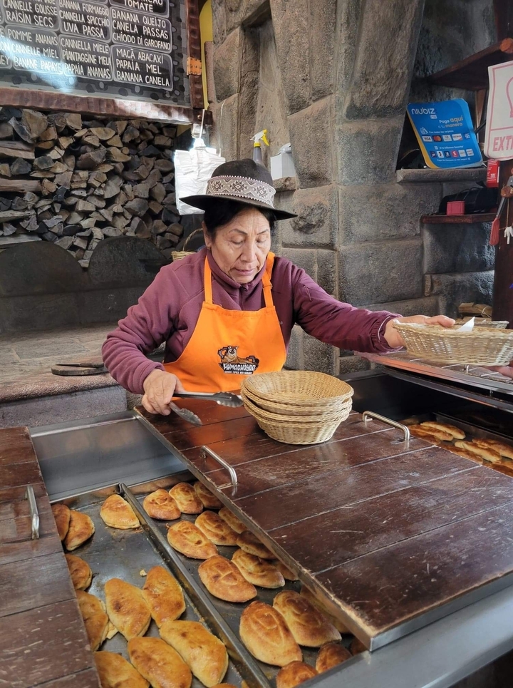 Local woman in a kitchen setting with bread baskets.