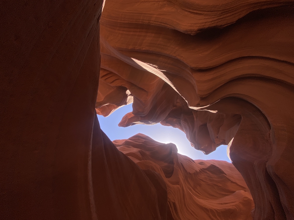 Narrow sandstone canyon with dramatic natural lighting.