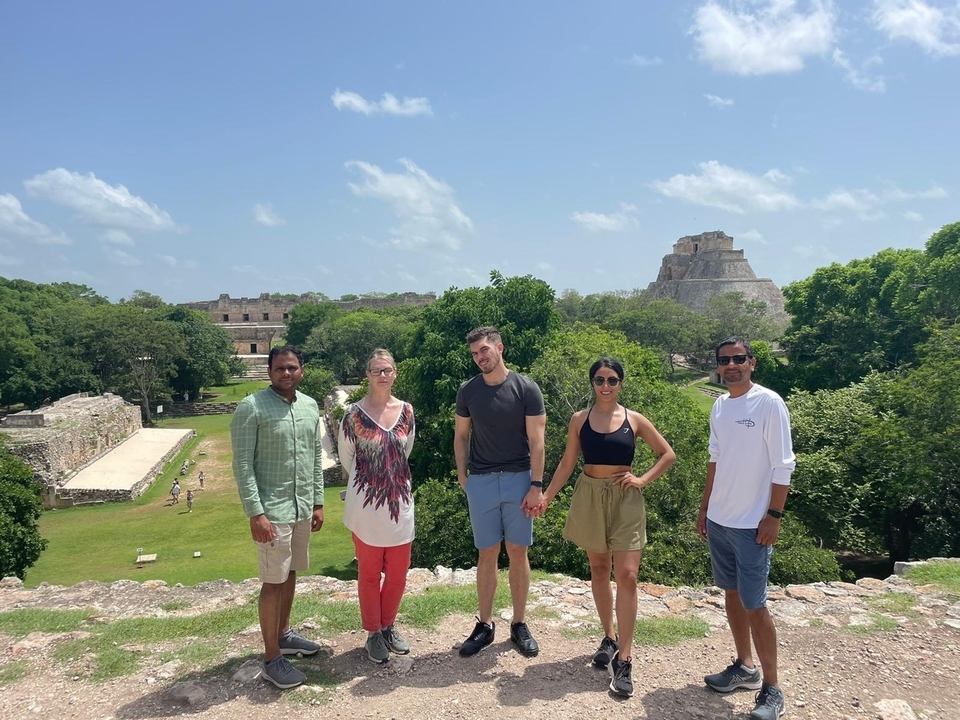 Group of people in front of ancient ruins.