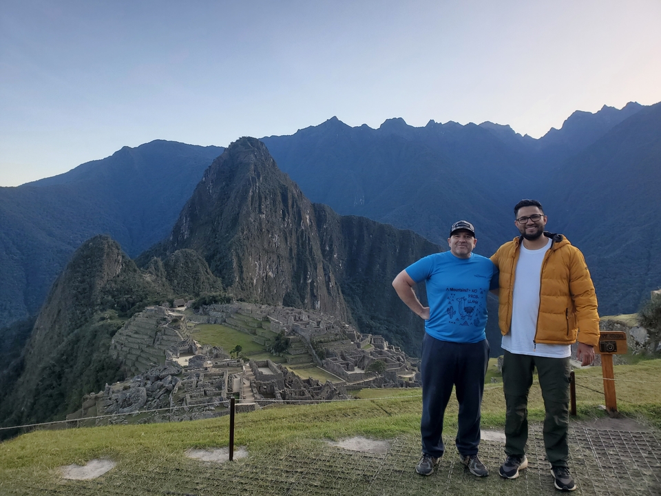 Two people posing in front of Machu Picchu.