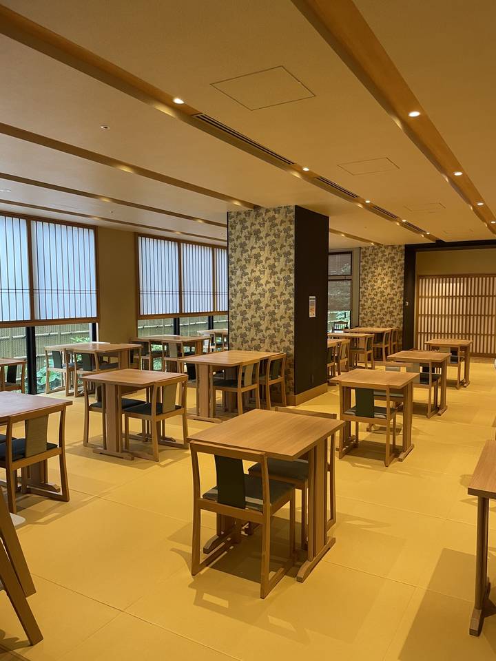Empty dining area with wooden tables and chairs.