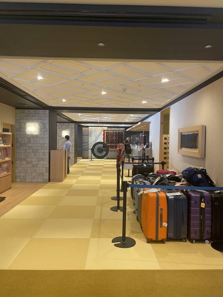 Hotel lobby with guests and luggage.