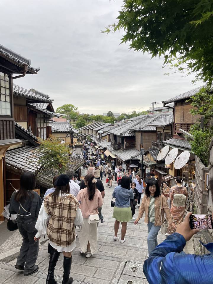 Crowded street with shops and people.
