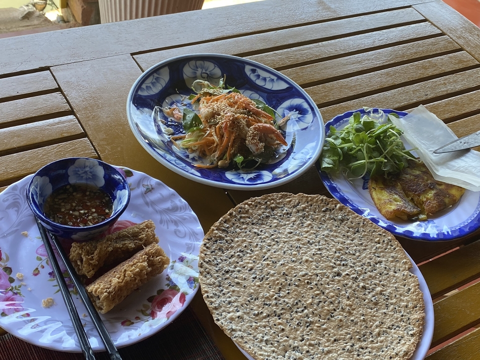 A table with traditional Vietnamese dishes and sauces.
