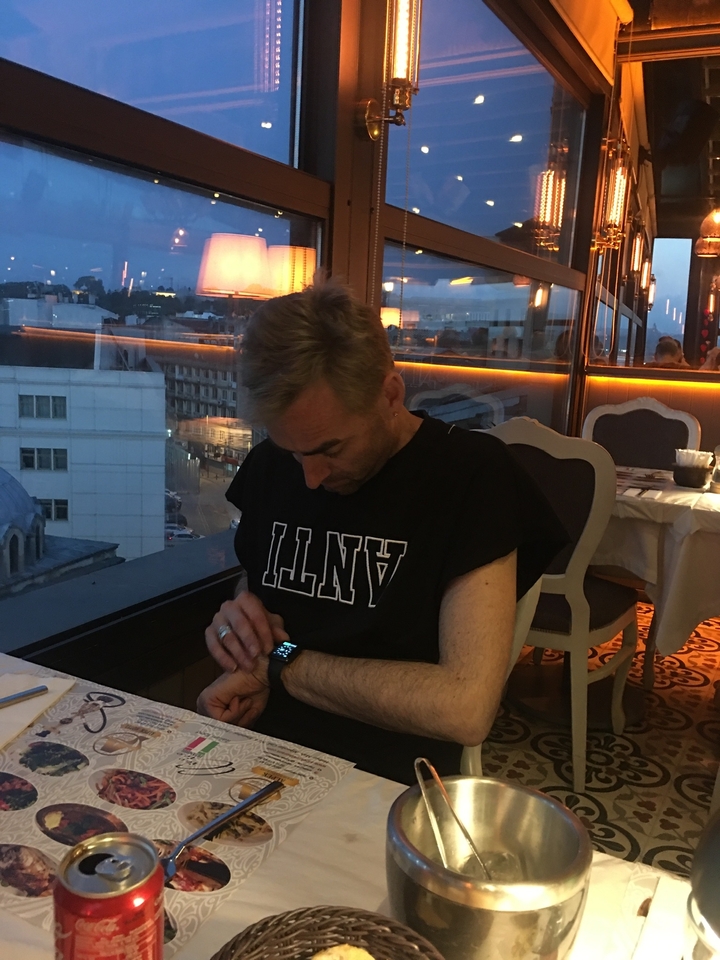 Personne assise à une table dans un restaurant faiblement éclairé.