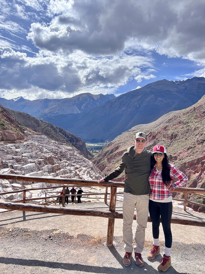 Two people posing at the Salt Mines of Maras.