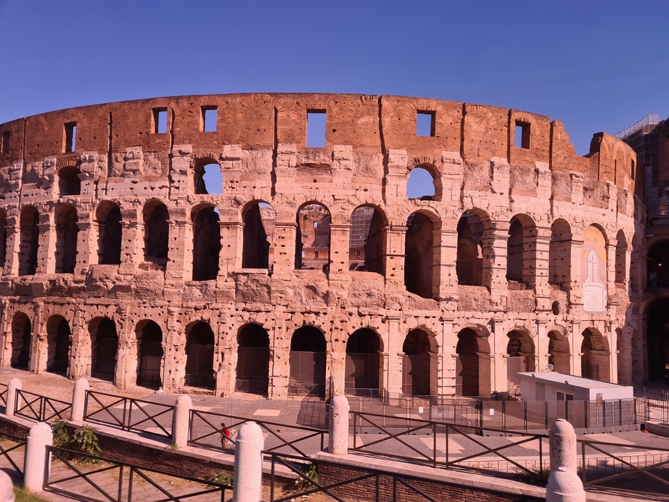 The Colosseum in Rome with arches and an ancient facade.