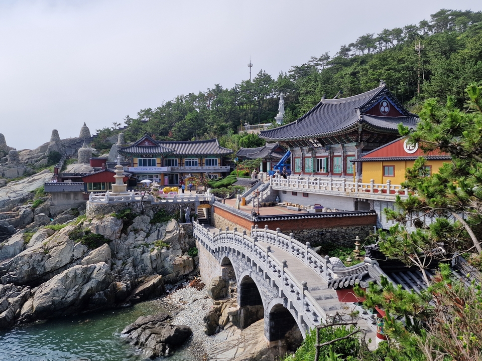 Temple on a rocky coast with intricate architecture.