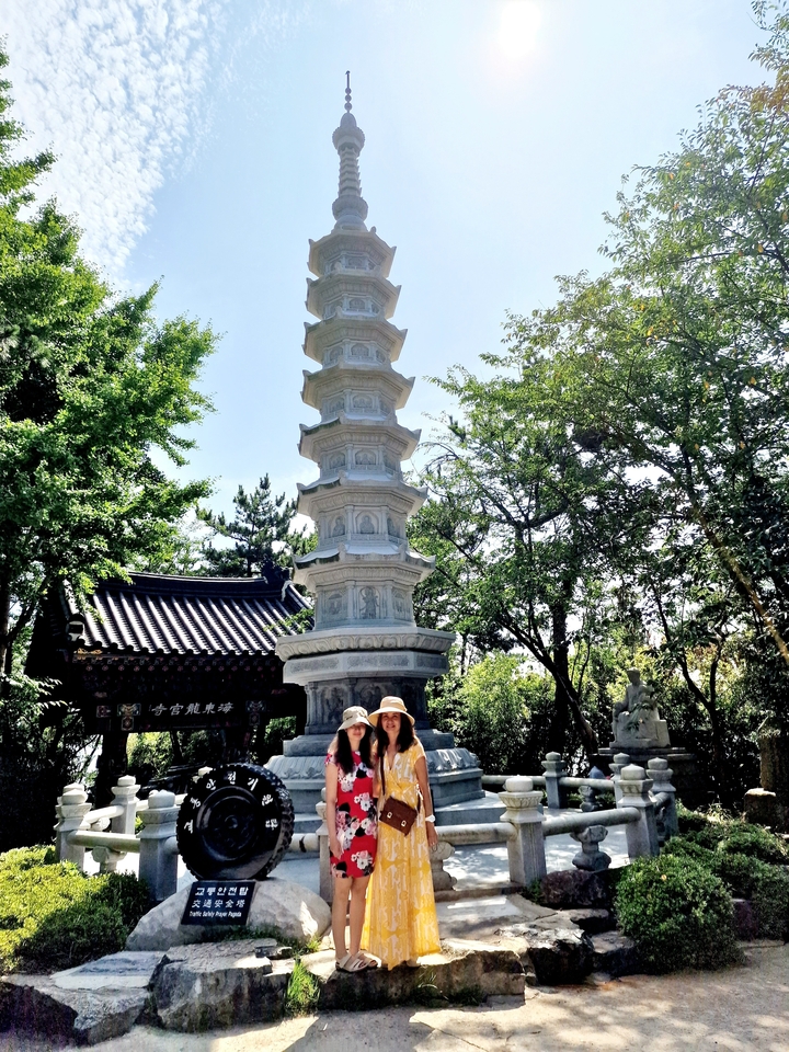 People with a pagoda in a lush garden.