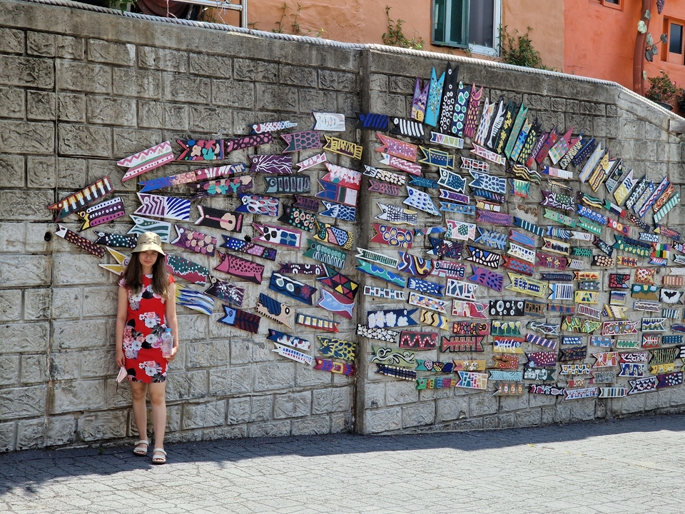 Artistic wall with a person standing beside it.